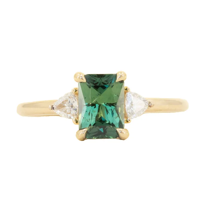 116ct Teal Green Radiant Cut Montana Sapphire and Trillion Diamond Low Profile Three Stone ring in 14k Yellow Gold Anueva Jewelry Rings 116ct Teal Green Radiant Cut Montana Sapphire and Trillion Diamond Low Profile Three Stone ring in 14k Yellow Gold Anueva Jewelry Rings