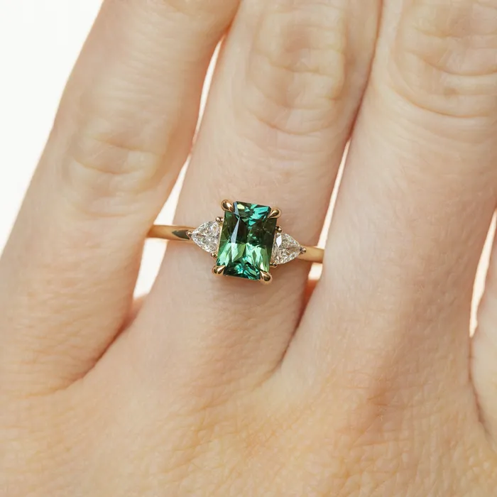 116ct Teal Green Radiant Cut Montana Sapphire and Trillion Diamond Low Profile Three Stone ring in 14k Yellow Gold Anueva Jewelry Rings
